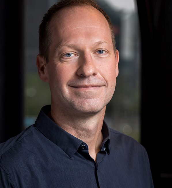 A portait photo of ANE Communications and Networking Manager, Kristoffer Boesen. Kristoffer wears a dark shirt.